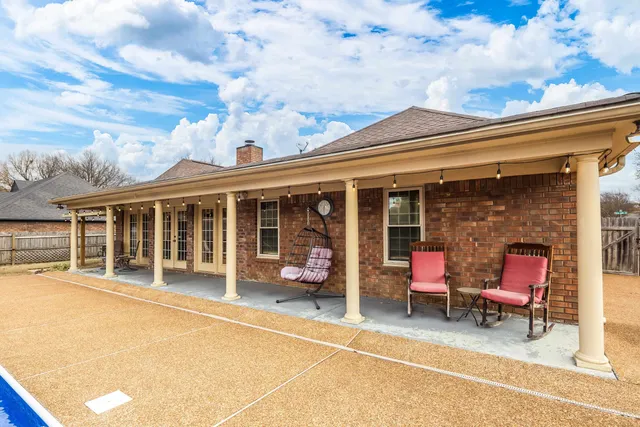 a man sitting on a bench in front of a building