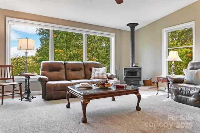 a living room with furniture a flat screen tv and a large window