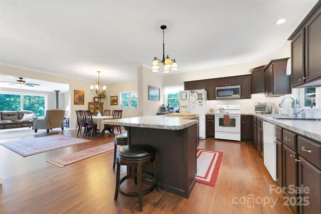 a kitchen with granite countertop wooden cabinets and center island