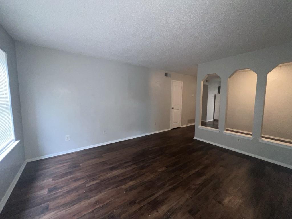 219 Fry Street, Unit 7 Denton, TX 76201 - Photo 3 of 9 a view of wooden floor and windows in a room