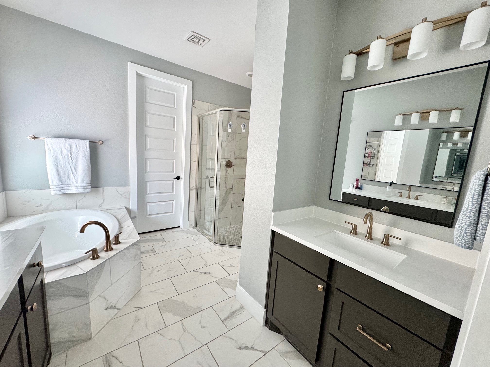 561 Cold Riv Run Kyle, TX 78640 - Photo 11 of 33 a bathroom with a sink vanity granite tub shower and mirror