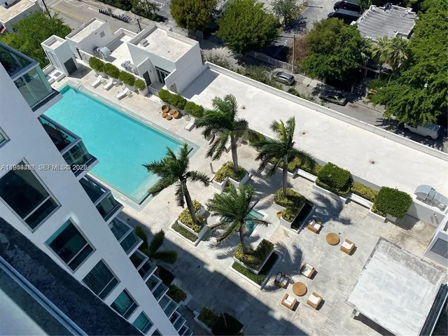 a view of a patio with table and chairs potted plants and palm trees