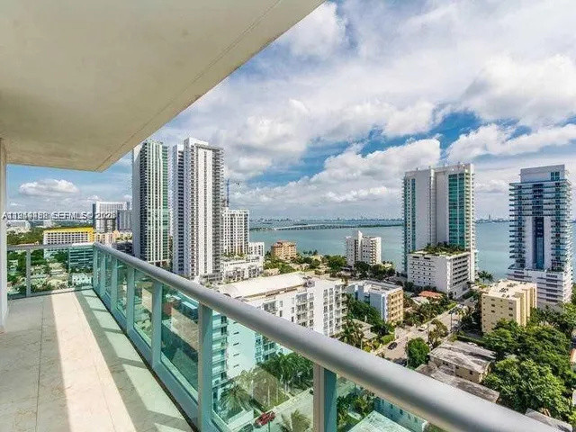 a city view from a balcony with outdoor seating