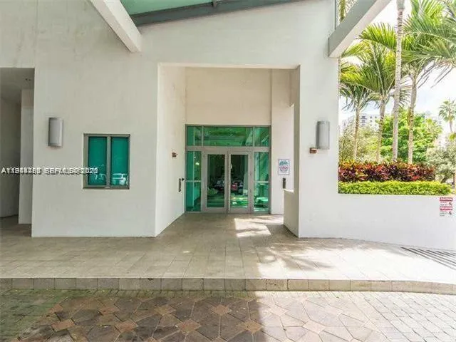 a living room with furniture gym equipment and floor to ceiling windows