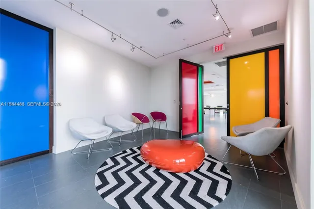 a living room with furniture and flowers