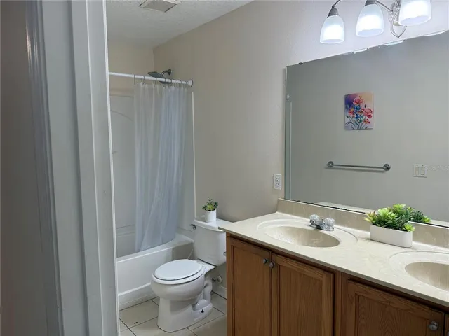 a bathroom with a sink vanity mirror and toilet