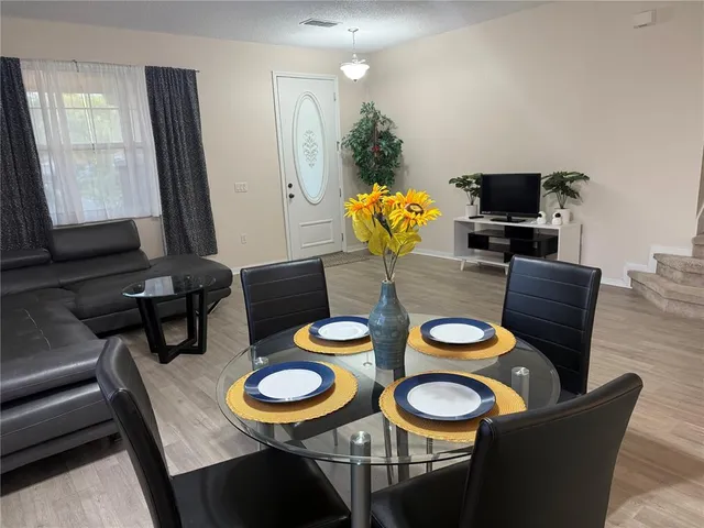 a dining room with furniture and wooden floor