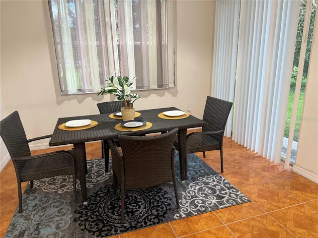 a view of a dining room with furniture and a window