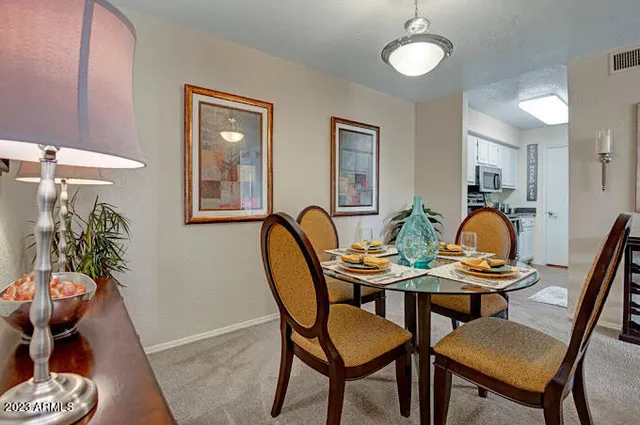 a dining room with furniture and wooden floor