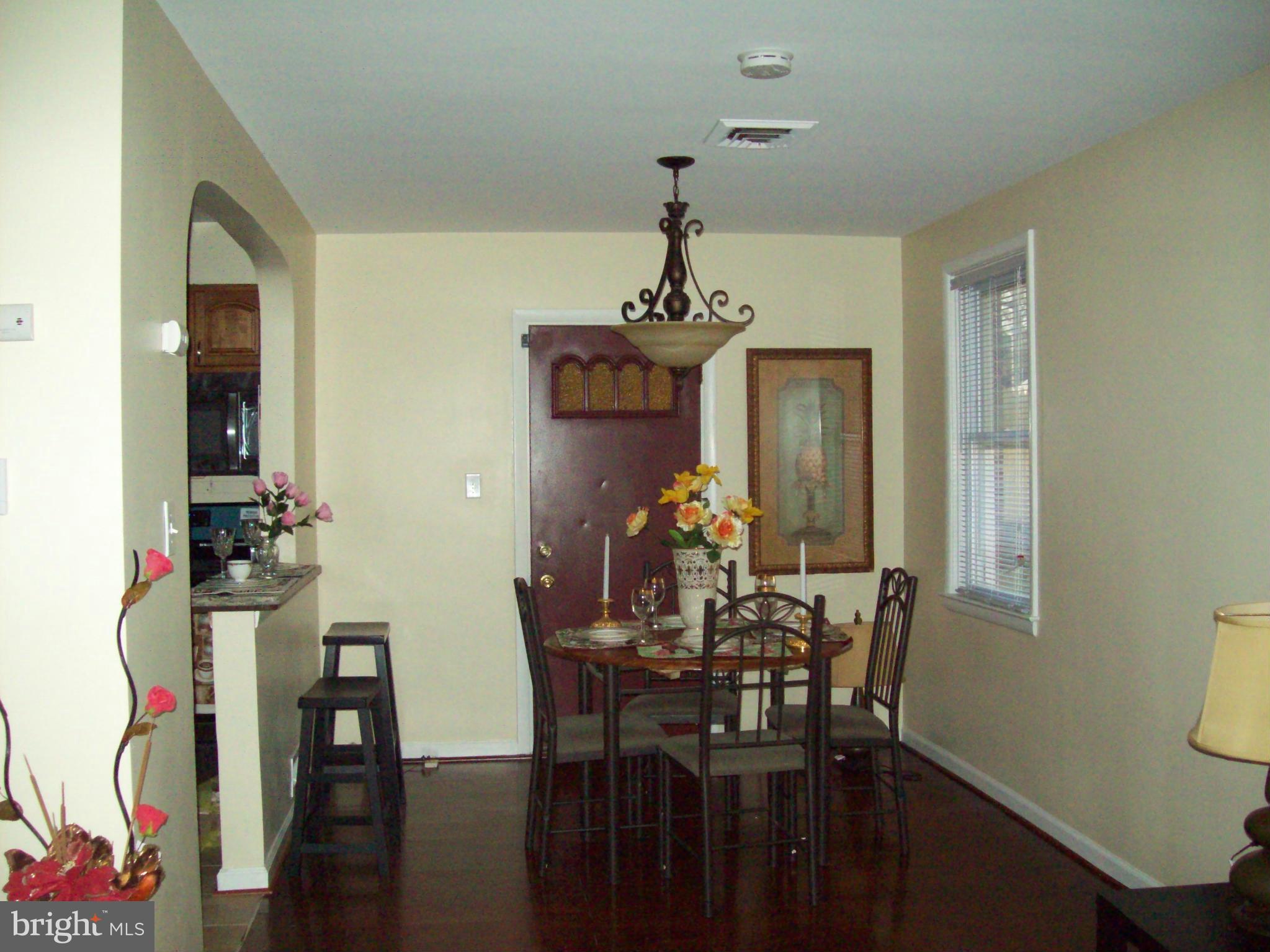 3516 Mayfair Road Baltimore, MD 21207 - Photo 6 of 10 a view of a dining room with furniture and chandelier