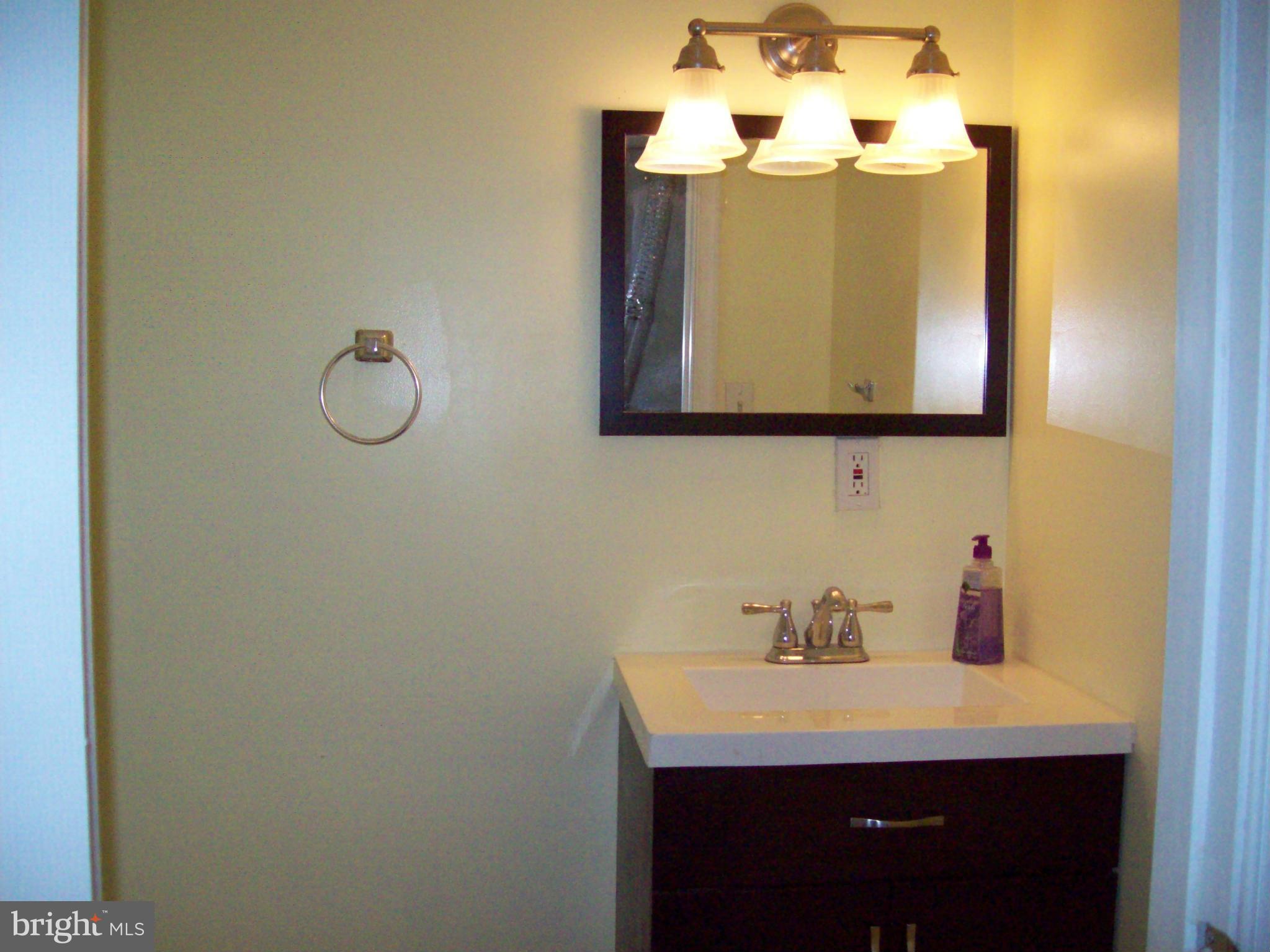 3516 Mayfair Road Baltimore, MD 21207 - Photo 9 of 10 a bathroom with a sink and a mirror