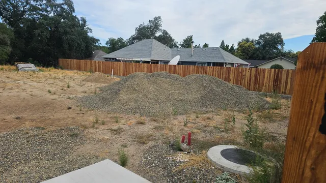 a backyard of a house with table and chairs