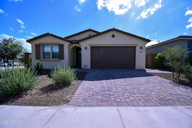 a front view of a house with a yard and garage
