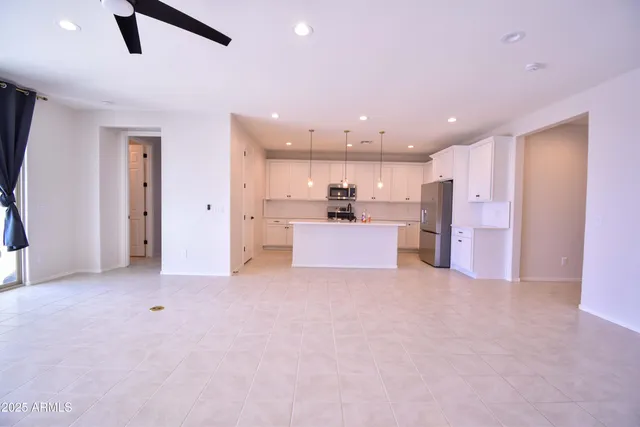 a view of a kitchen with refrigerator and microwave
