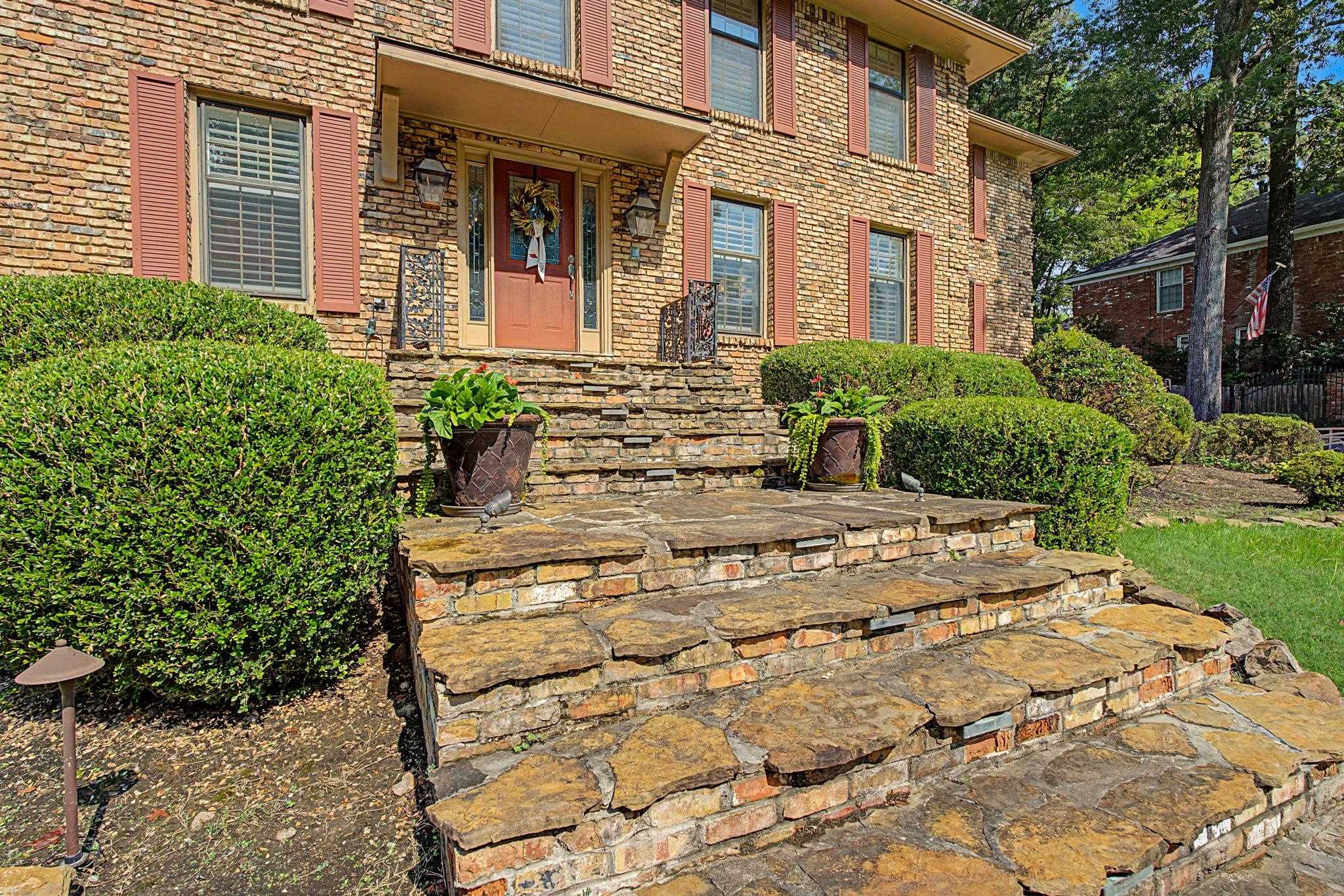 1929 Miller Farms Road Germantown, TN 38138 - Photo 4 of 40 Brick exterior featuring red shutters and a solid wood front door