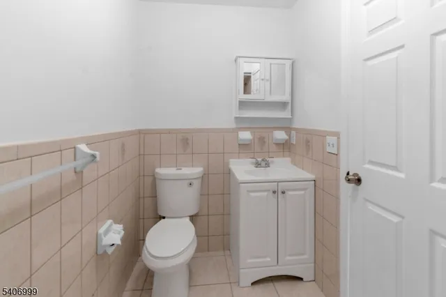 a bathroom with a toilet sink and vanity