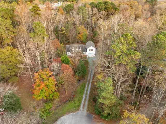 a view of a yard with plants and wooden fence