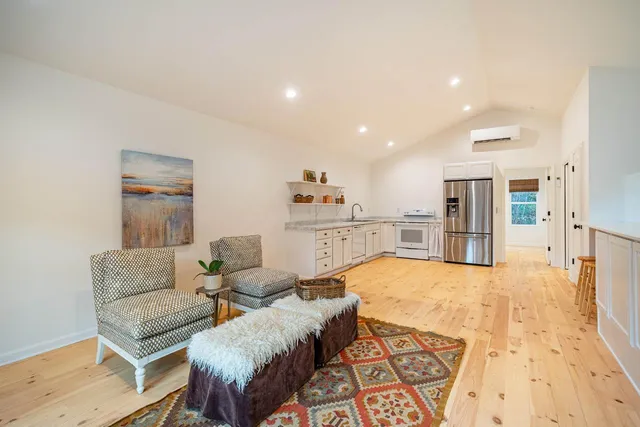 a living room with furniture and kitchen view