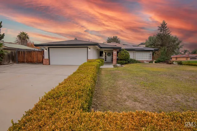 a yellow house with a yard