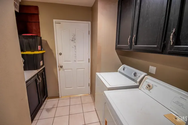 a potted plant sitting in front of a house with a garden