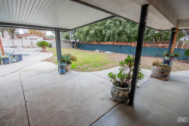 a view of a porch with chairs and backyard