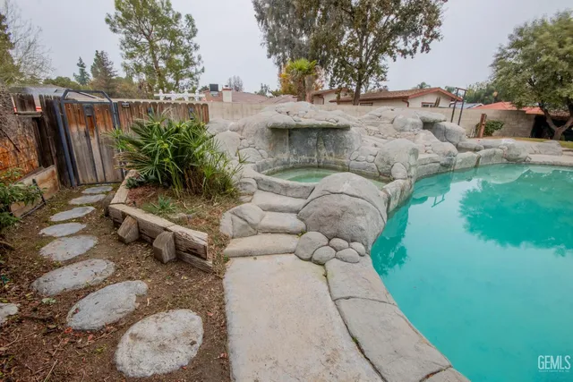 a backyard of house with a yard and a stove