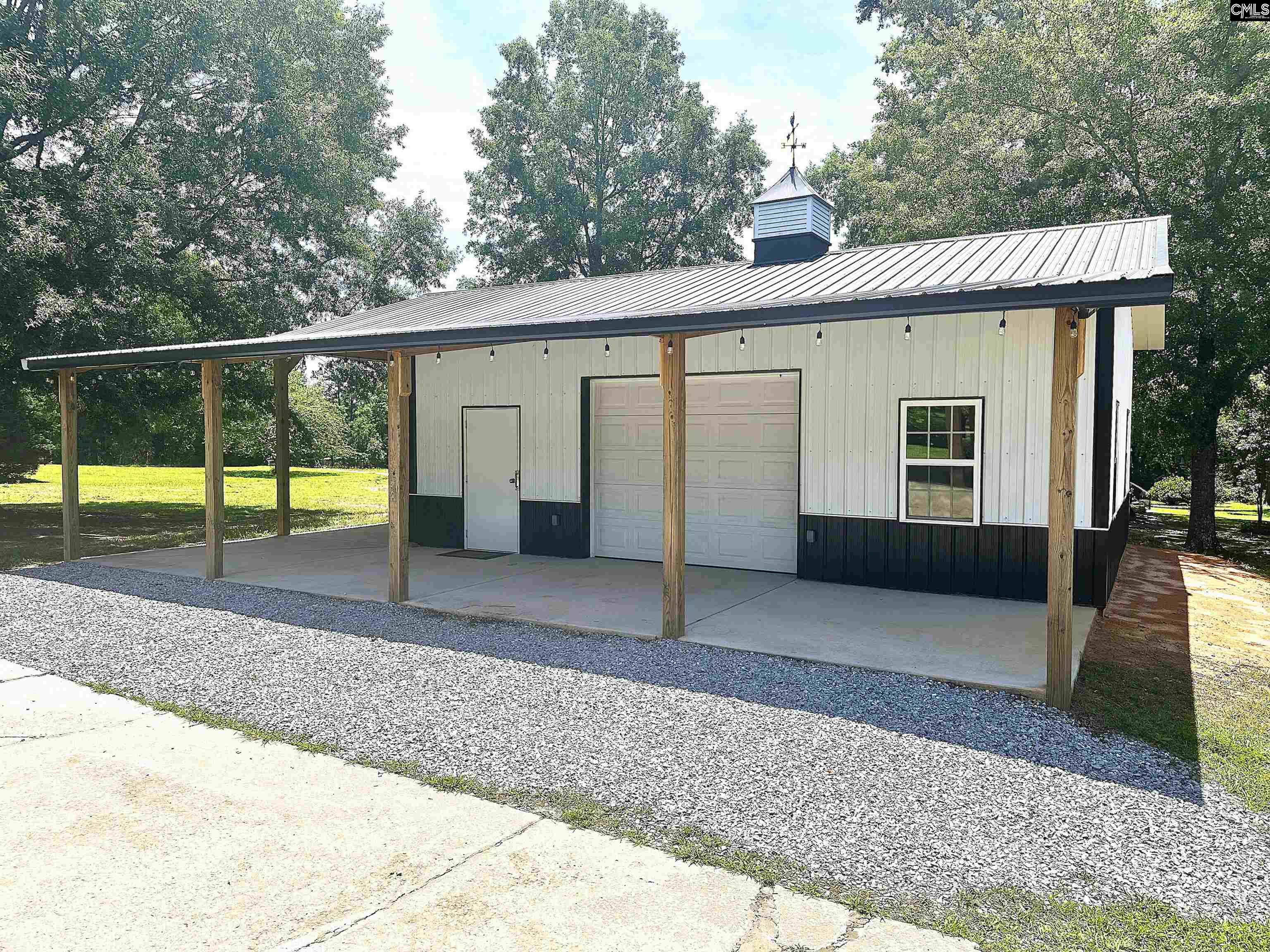 535 Sandbar Road Chapin, SC 29036 - Photo 5 of 23 a view of a house with a backyard and a patio