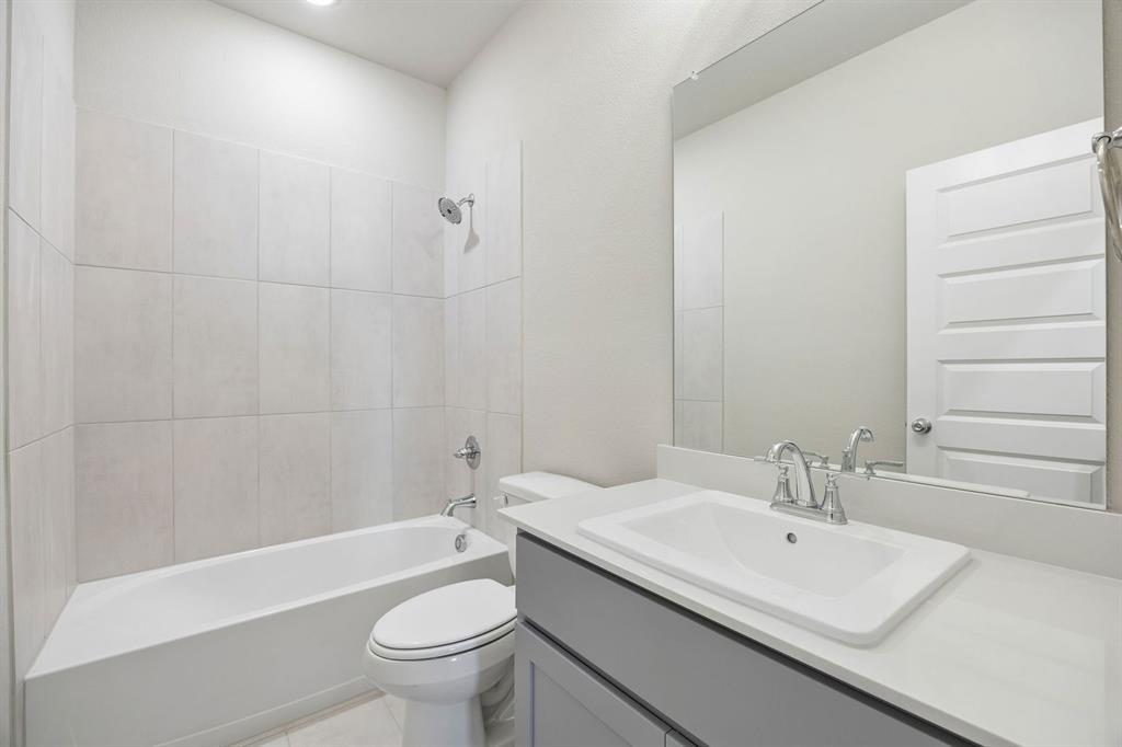 1441 Companero Street Haslet, TX 76052 - Photo 27 of 33 a bathroom with a sink a toilet and shower