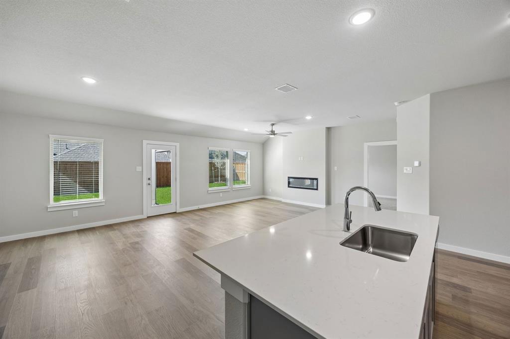 1441 Companero Street Haslet, TX 76052 - Photo 32 of 33 a kitchen with a sink and a refrigerator
