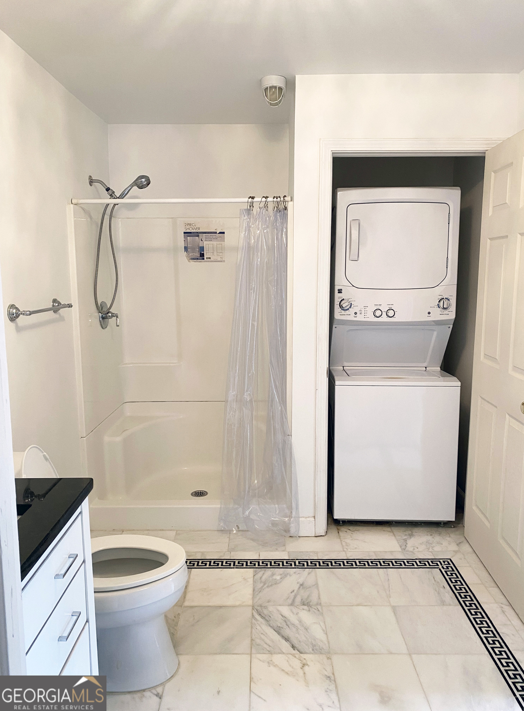 4266 Roswell Road Northeast, Unit K2 Atlanta, GA 30342 - Photo 12 of 18 a bathroom with a granite countertop sink a toilet and shower
