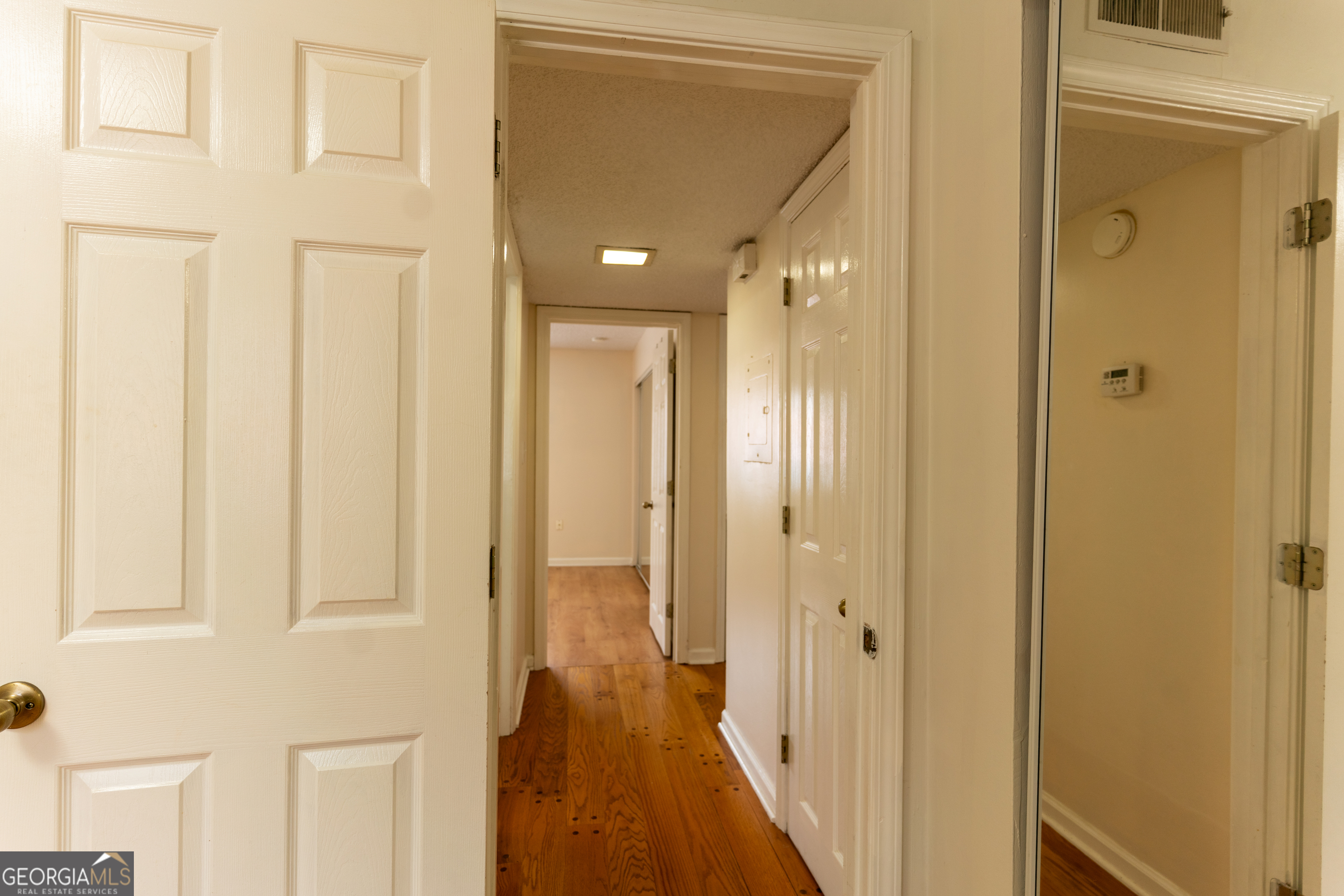 4266 Roswell Road Northeast, Unit K2 Atlanta, GA 30342 - Photo 13 of 18 a view of a hallway with a wooden door