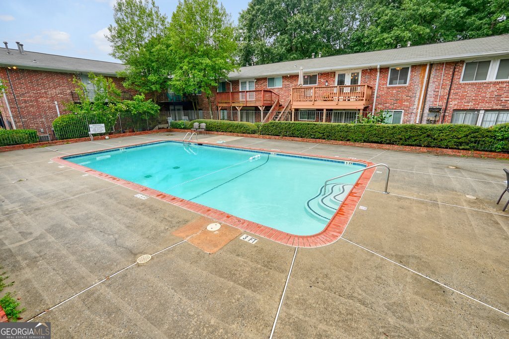 4266 Roswell Road Northeast, Unit K2 Atlanta, GA 30342 - Photo 17 of 18 a view of a house with a swimming pool