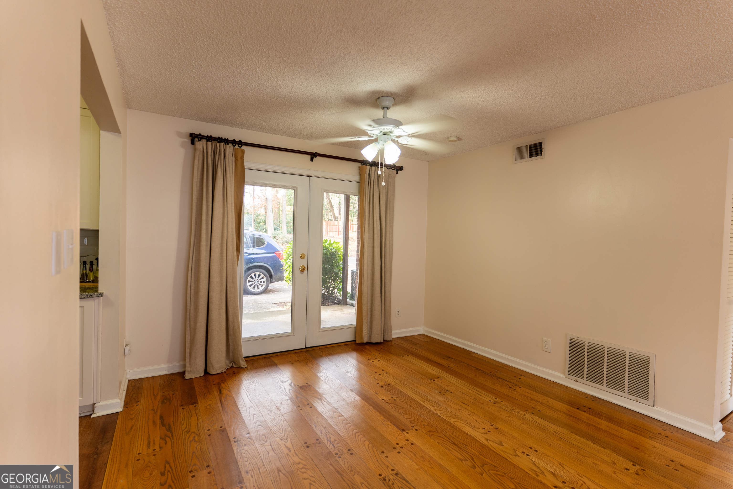 4266 Roswell Road Northeast, Unit K2 Atlanta, GA 30342 - Photo 2 of 18 an empty room with wooden floor and windows