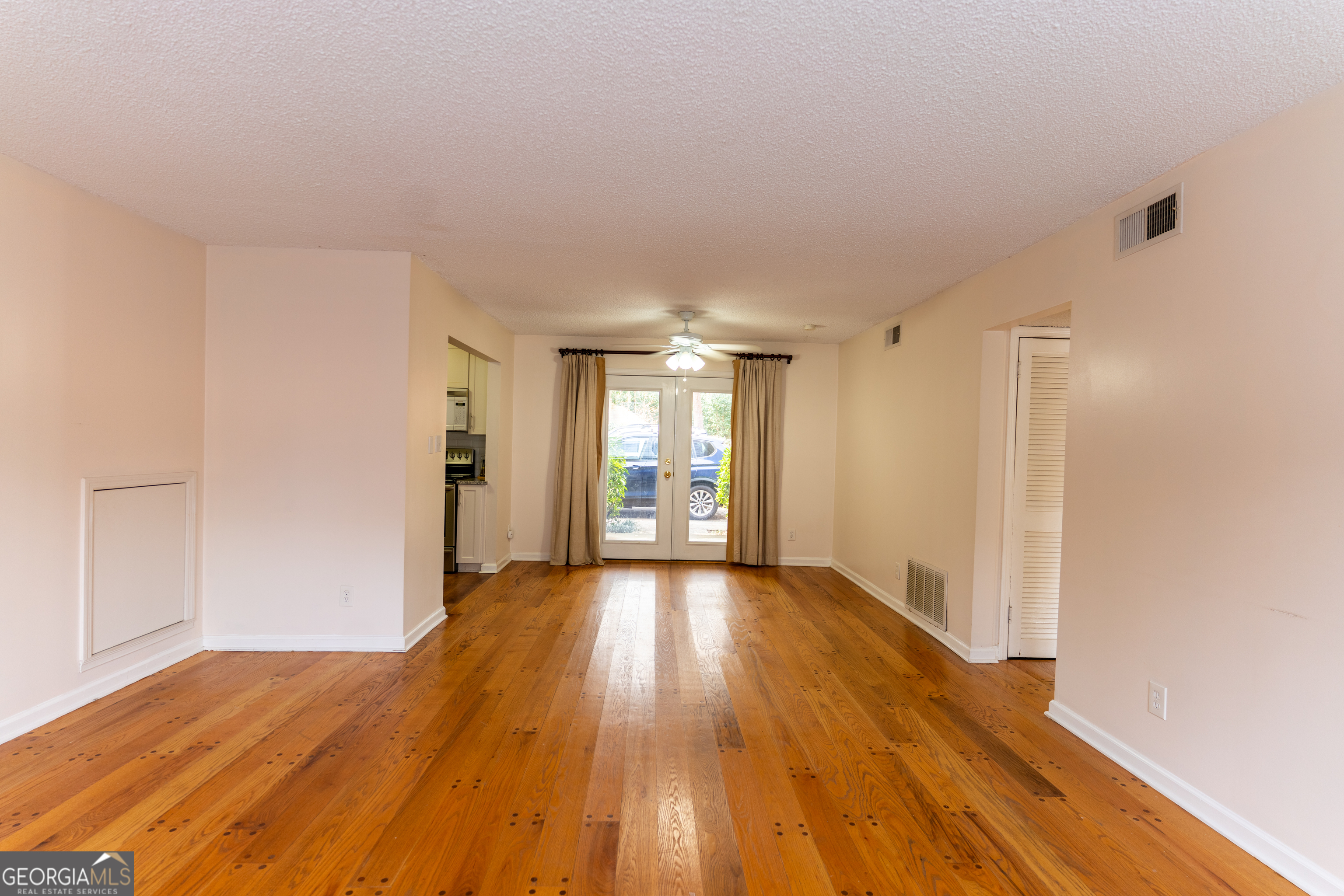 4266 Roswell Road Northeast, Unit K2 Atlanta, GA 30342 - Photo 3 of 18 a view of an empty room with wooden floor and a window