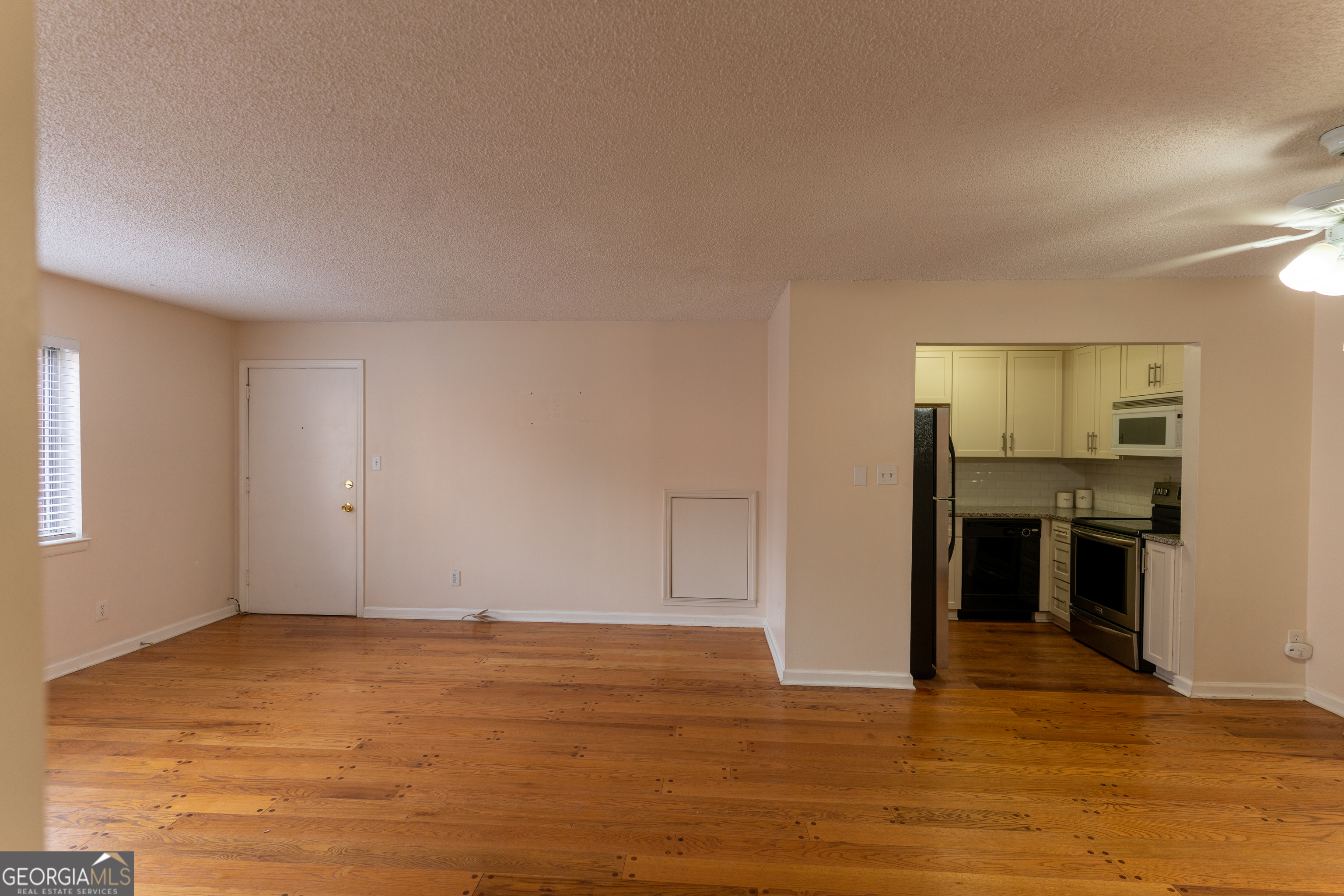 4266 Roswell Road Northeast, Unit K2 Atlanta, GA 30342 - Photo 6 of 18 a view of an empty room with kitchen and a window