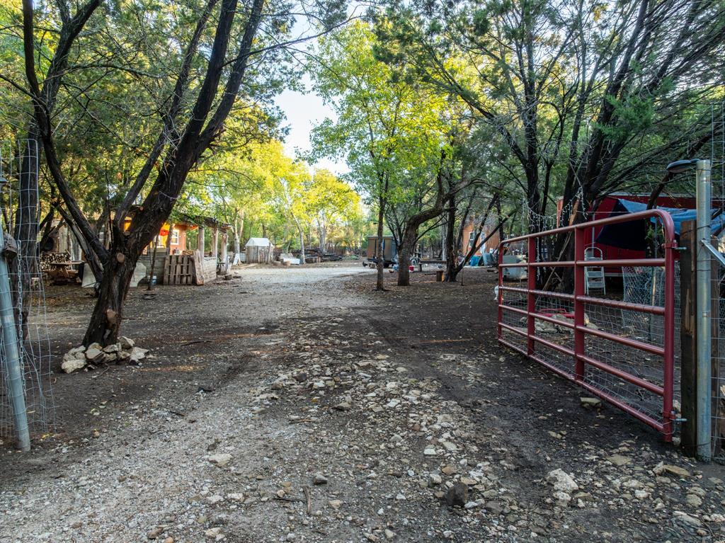 View of street featuring a gated entry and a gate