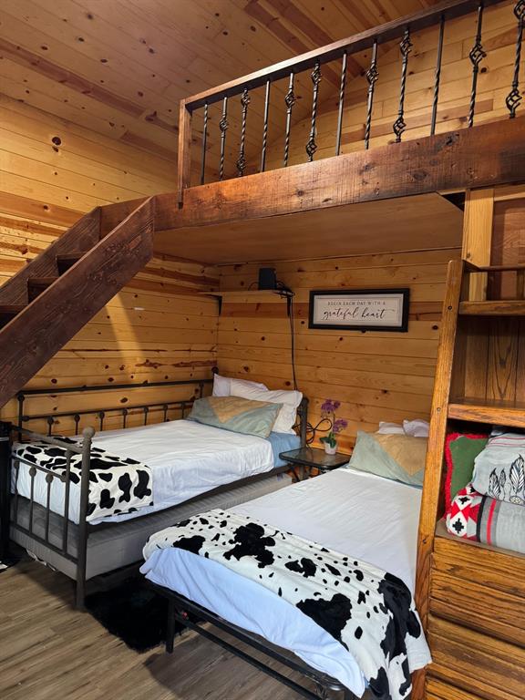 429 County Road 1191 Kopperl, TX 76652 - Photo 13 of 30 Bedroom with wood finished floors, wooden walls, and wooden ceiling