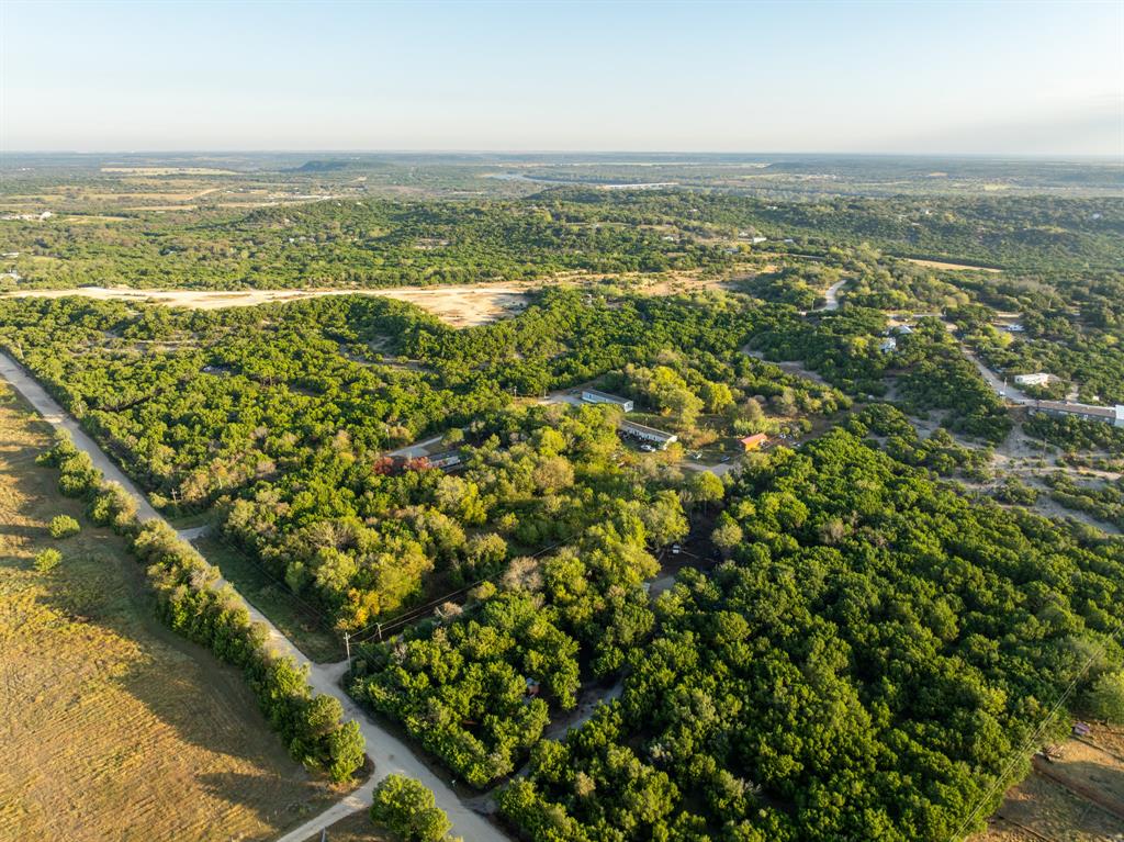 429 County Road 1191 Kopperl, TX 76652 - Photo 26 of 30 Aerial view of property and surrounding area with a heavily wooded area