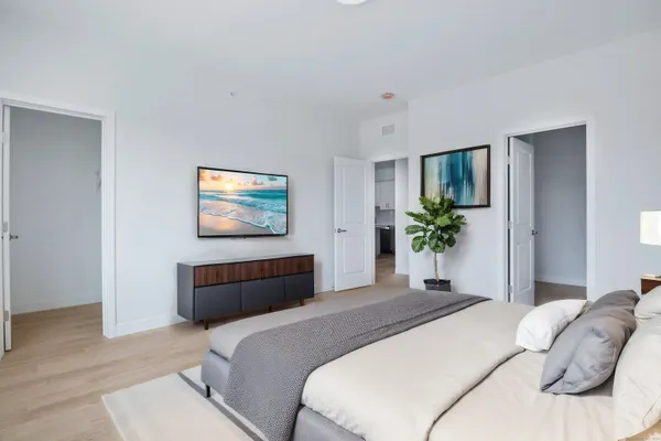 a bedroom with a bed and a large mirror