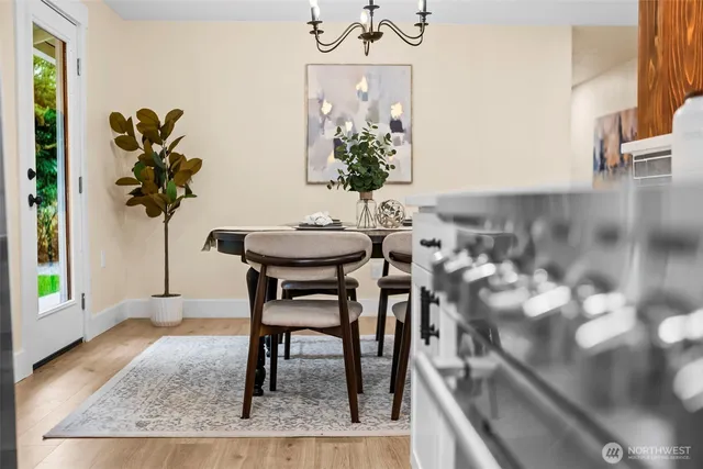 a view of a dining room with furniture and a potted plant