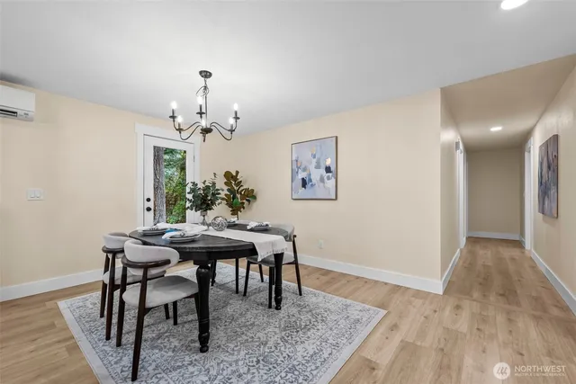 a view of a dining room with furniture and chandelier