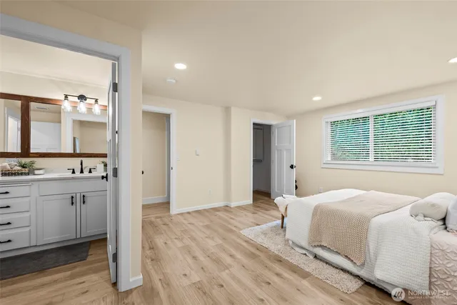 a spacious bedroom with a bed and a dresser