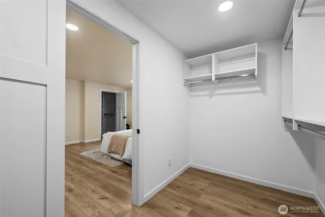 a view of hallway with wooden floor