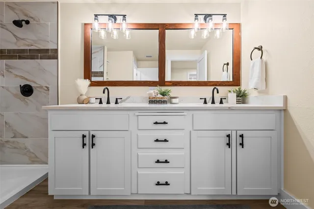 a bathroom with a sink vanity and a mirror