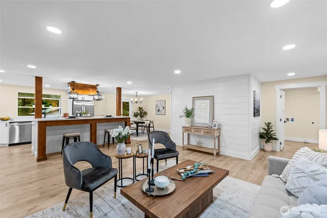 a living room with furniture and wooden floor
