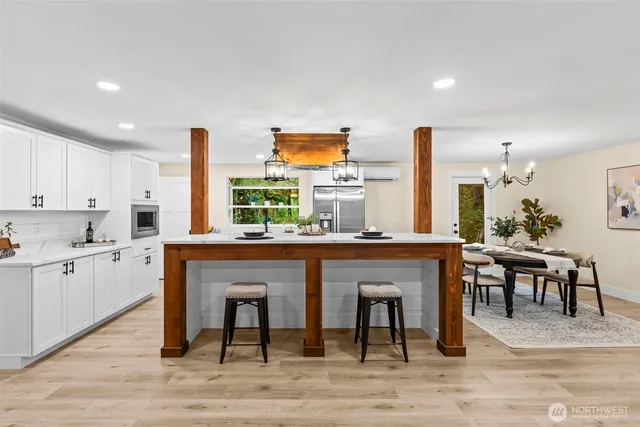 a kitchen with a table chairs sink and cabinets
