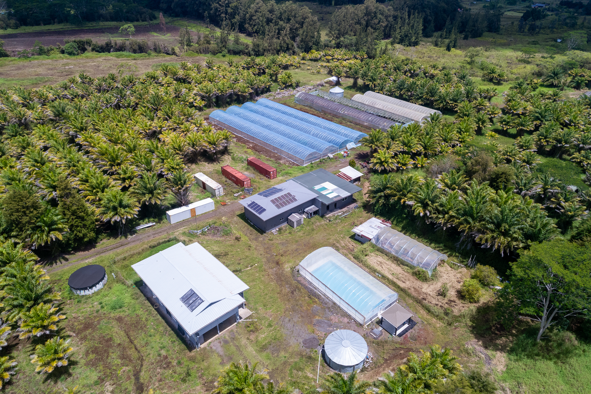 18-3840 South Lauko Road Mountain View, HI 96771 - Photo 1 of 30 an aerial view of a house with garden space and lake view