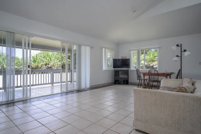 a living room with furniture a window and stainless steel appliances