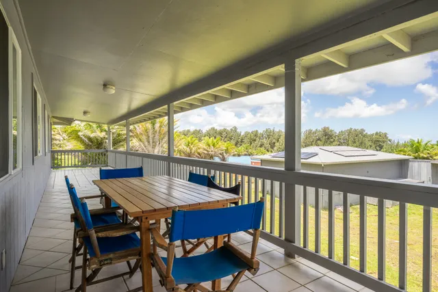 a view of a city from a dining room with furniture and window
