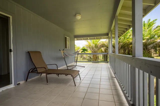 a view of two chairs in the balcony